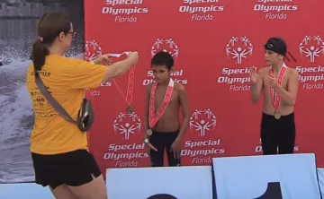 Young man winning medal at special olympics Florida